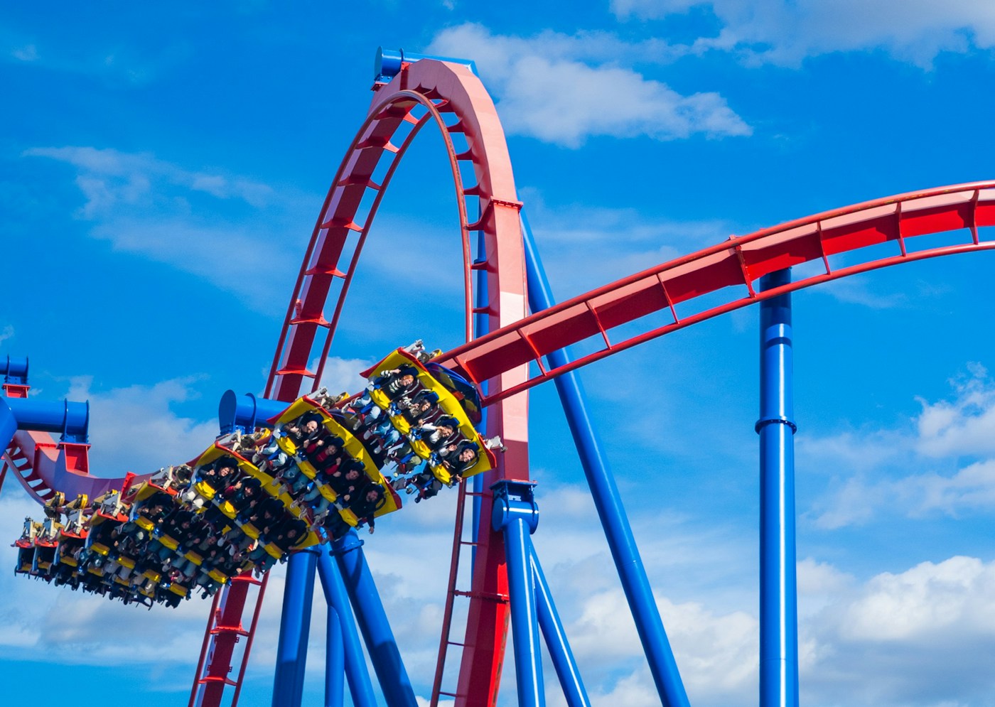 Roller coaster train turning along a red track